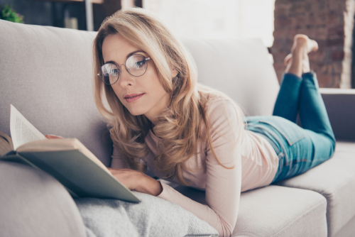 Lady on couch reading book