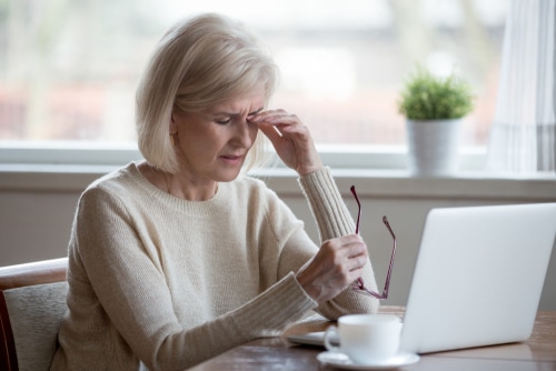 Older woman experiencing eye discomfort