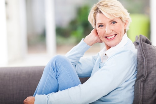 Woman sitting on a couch and smiling