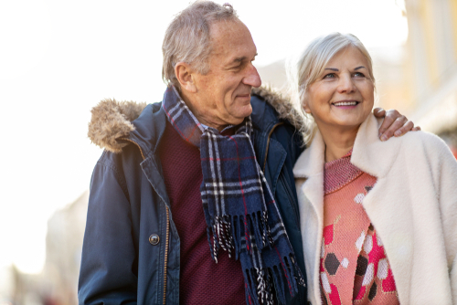 Older couple walking on street