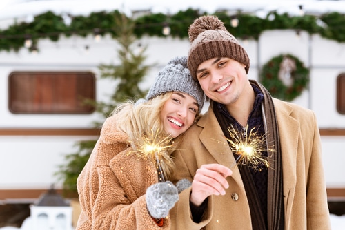 Happy couple outside in the winter with sparklers
