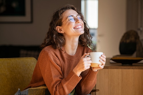 Happy young woman with coffee