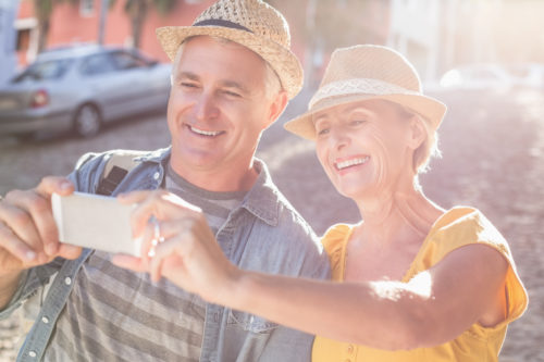 Happy older couple outside taking a selfie