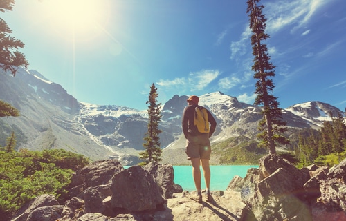 man hiking with mountains in the background