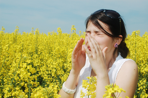 Woman suffering from allergies and dry eye in field